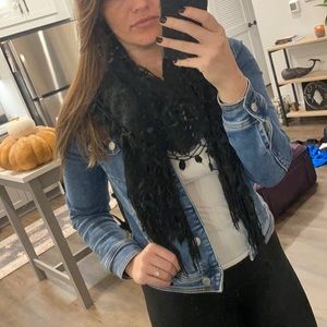 Long black lightweight knitted scarf with decorations fringe and knitting.